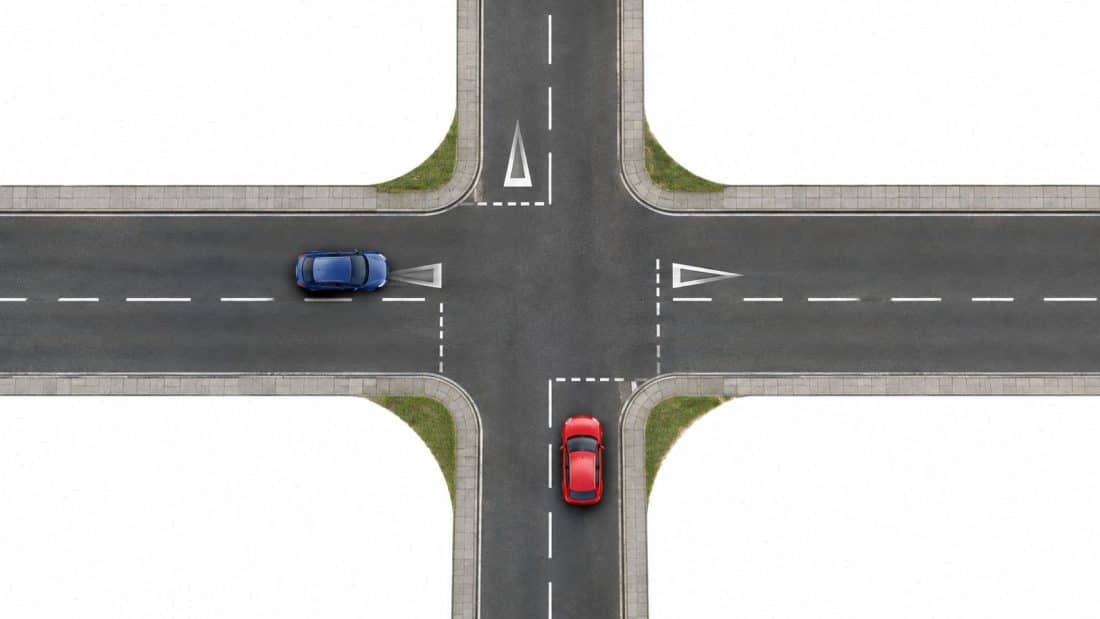 two way traffic crosses a two way road intersection cars