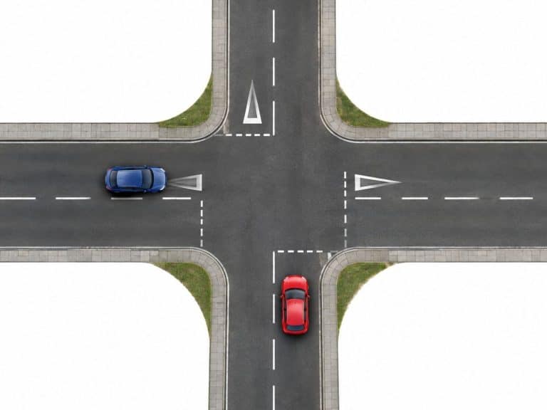 two way traffic crosses a two way road intersection cars